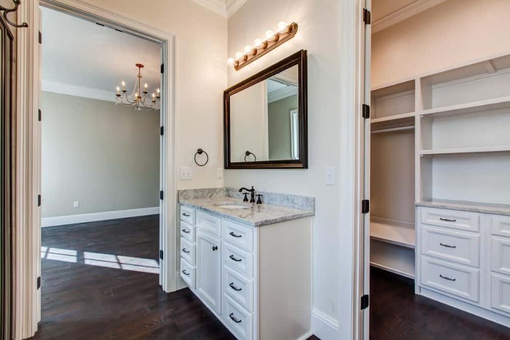 The primary bathroom includes a sink vanity and a walk-in closet.