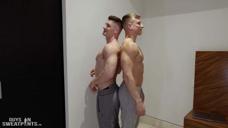 gay boyfriends James Cassidy and Bryce Jax standing shirtless in grey sweatpants standing back to back for guys in sweatpants gay xxx porn photos