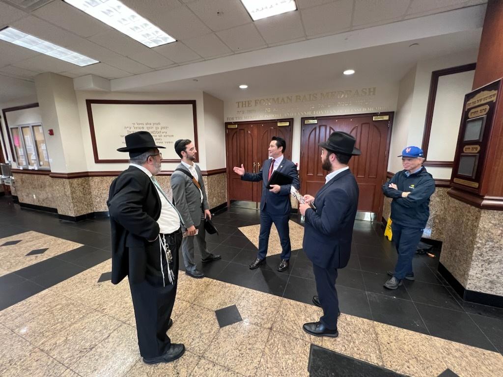 A group of men in suits in a room

Description automatically generated