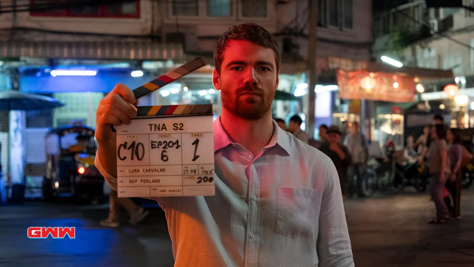 Gabriel Basso as Peter Sutherland with a Clapperboard in The Night Agent Season 2