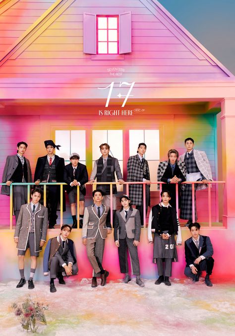 This contains an image of SEVENTEEN group members standing next to each other in front of a colorful building