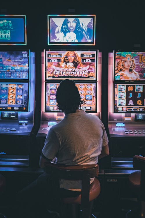 A person sitting at a slot machine

AI-generated content may be incorrect.