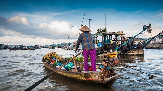 A person in a boat with a straw hat on

Description automatically generated