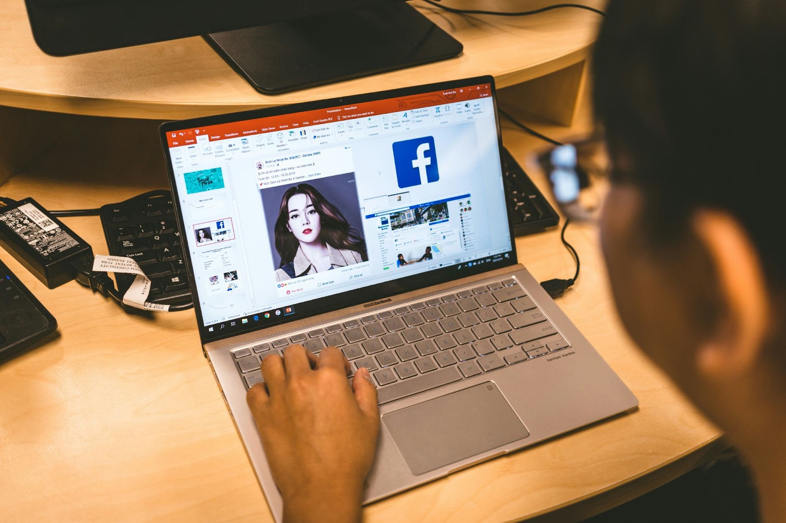 User working on a Facebook profile design on a laptop