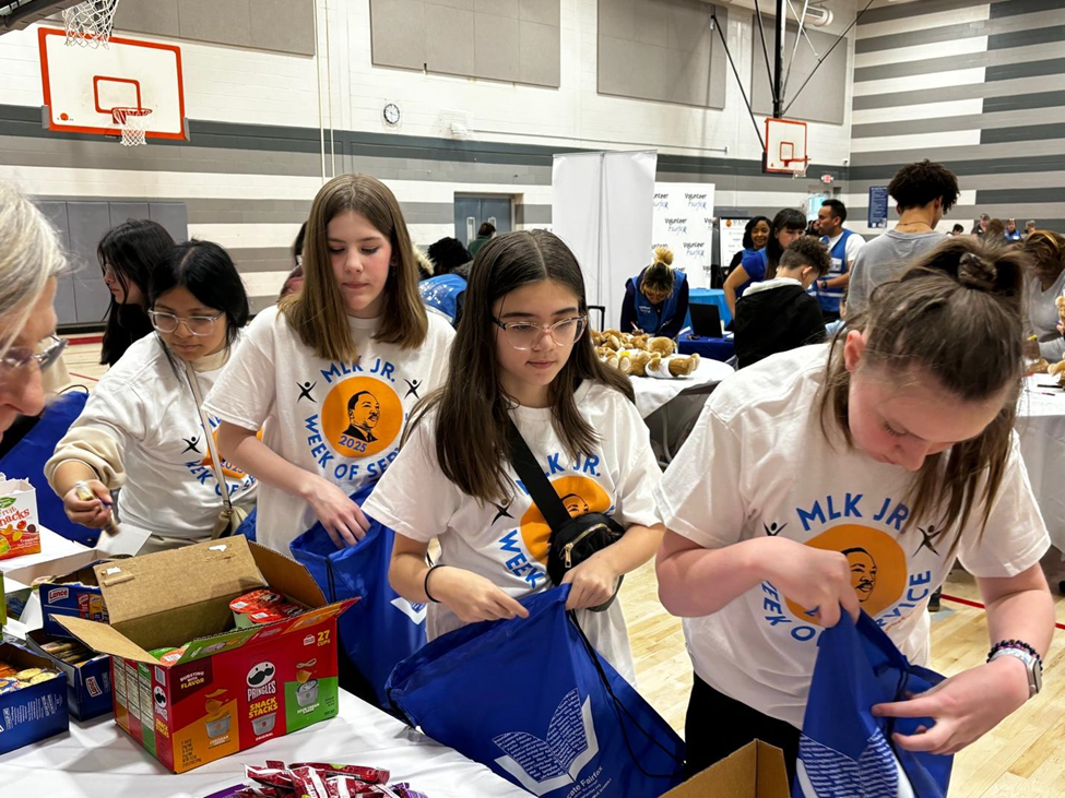 Elementary school students preparing snack bags as part of an MLK Day of Service. 