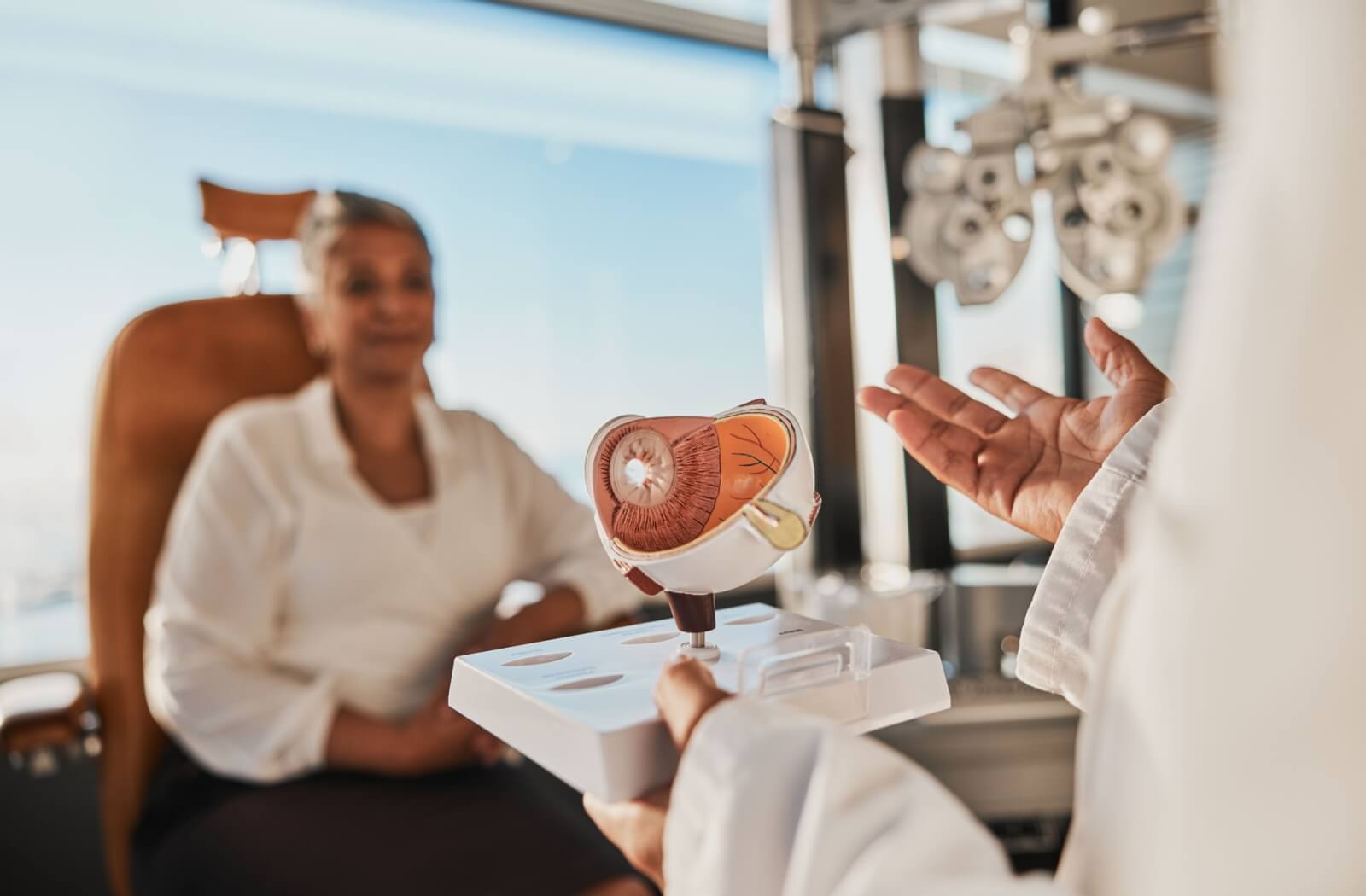 An optometrist explains how the shape of the eye impacts visual clarity to their patient during a routine eye exam.