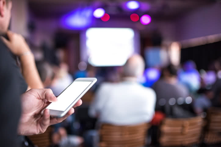 Picture of a smartphone being used at a conference.