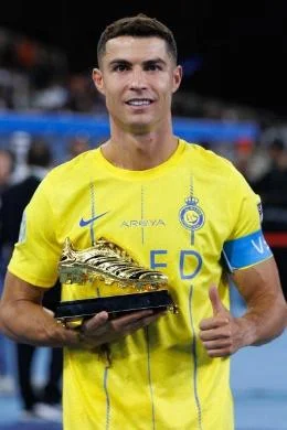 Nassr's Portuguese forward Cristiano Ronaldo poses with the top goalscorer trophy after winning the 2023 Arab Club Champions Cup after their final...