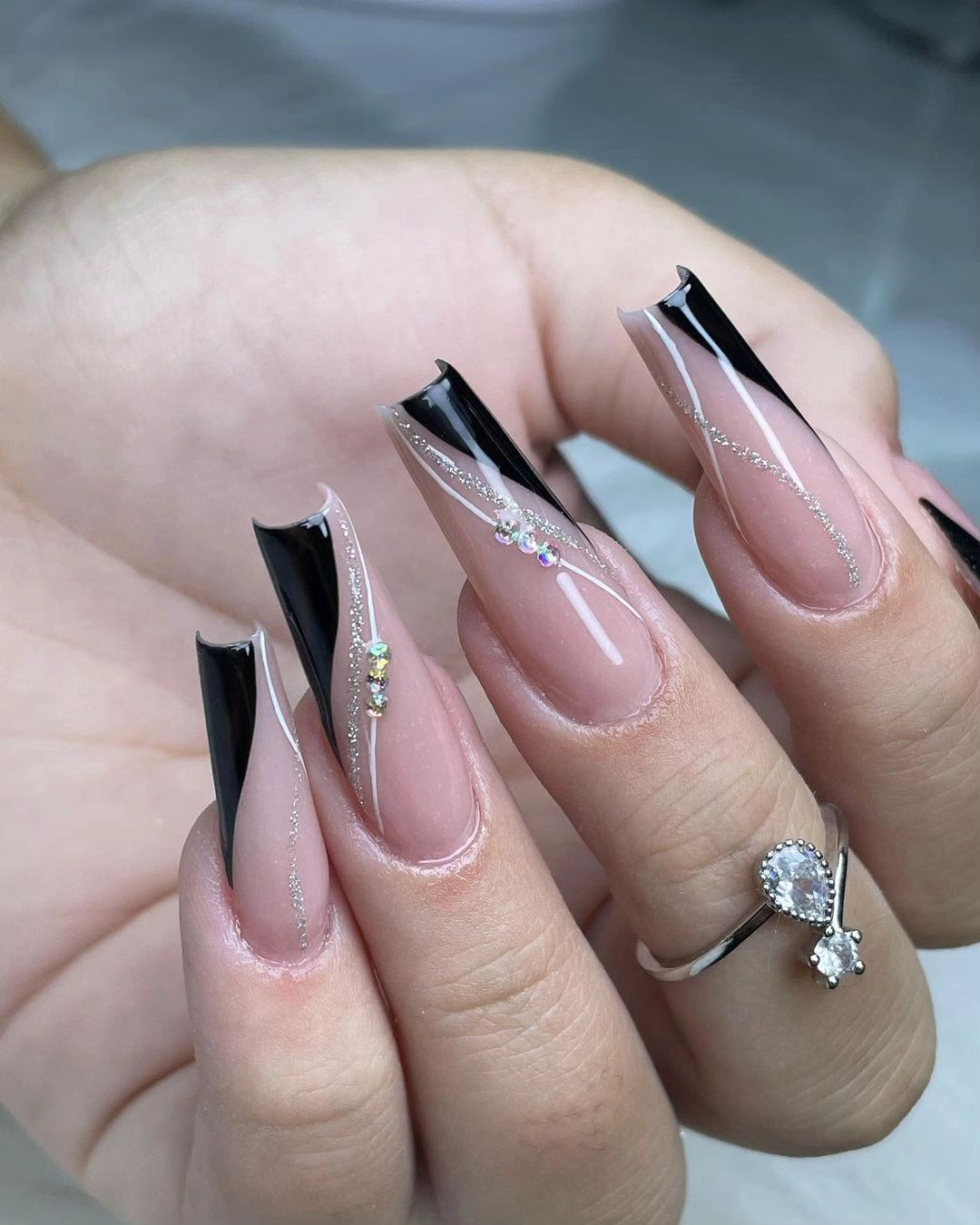 Close-up of a person's hands with black nails having Wedding-Appropriate Black Nail Designs