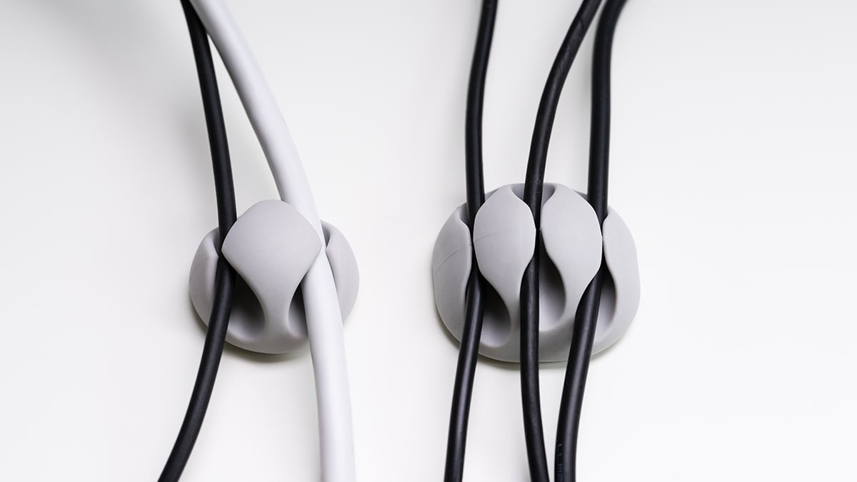 Close-up of a sticky pad cable organizer on a white background.