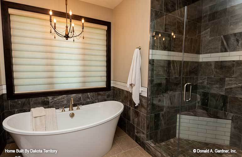 There's also a walk-in shower with a corner tiled seat and a glass hinged door.