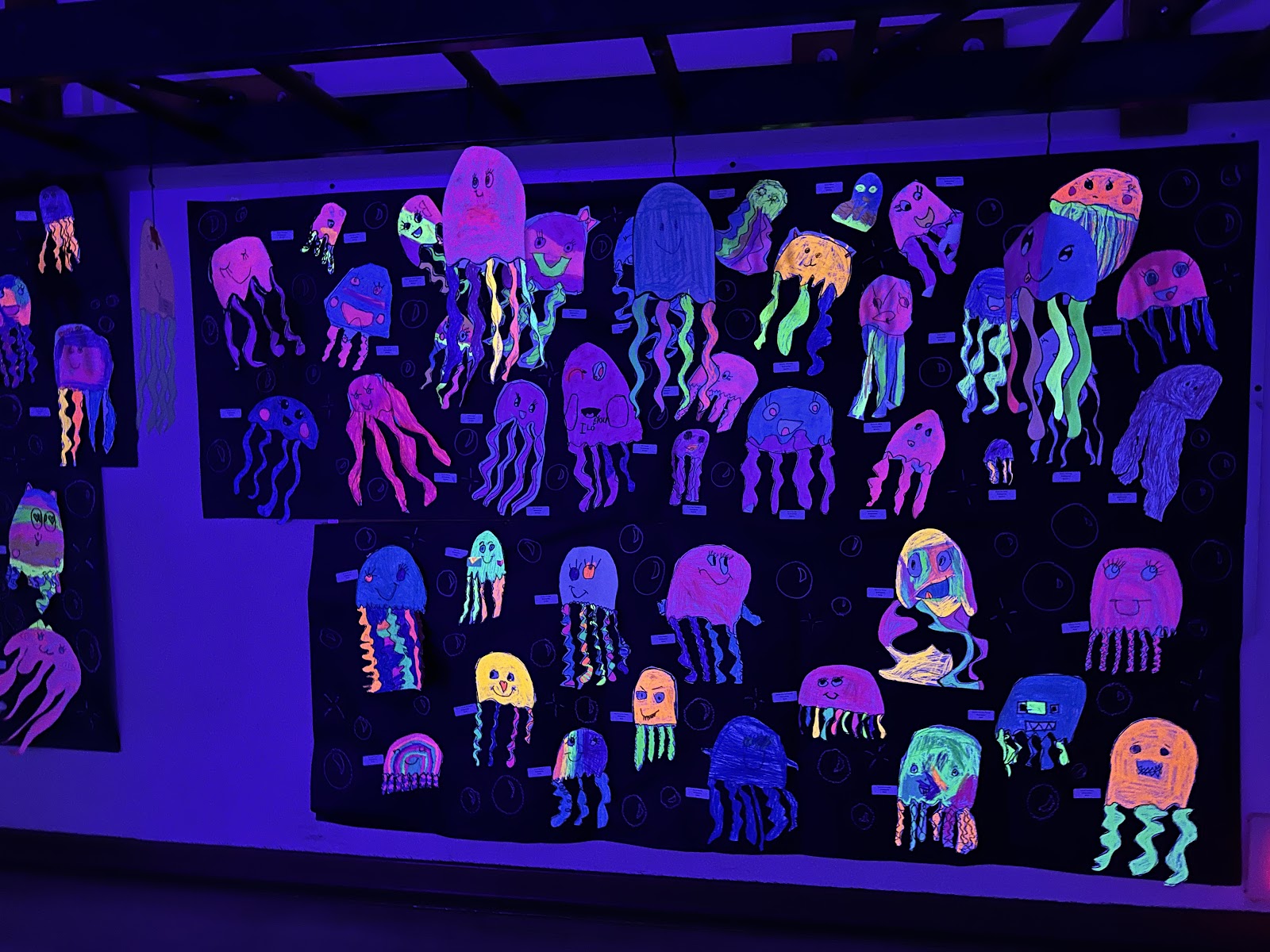Glow-in-the-dark student artwork on display