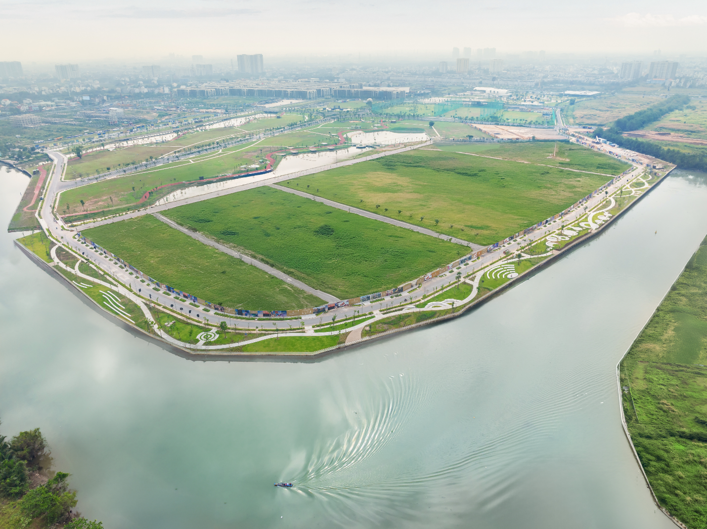 A green land with a body of water    AI-generated content may be incorrect.