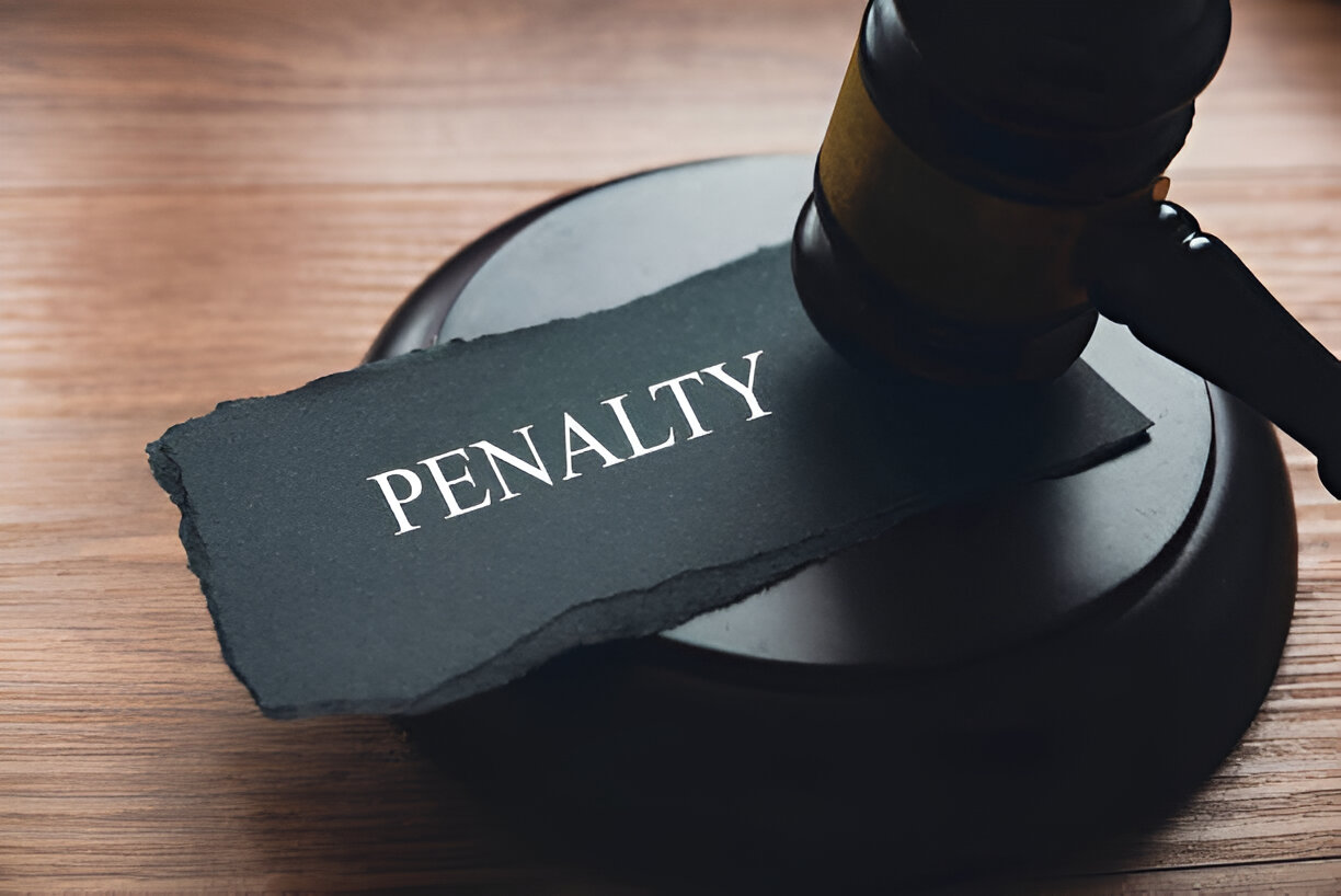 Gavel on a wooden desk with a paper labeled 'Penalty,' symbolizing the importance of bookkeeping in avoiding legal issues and fines.