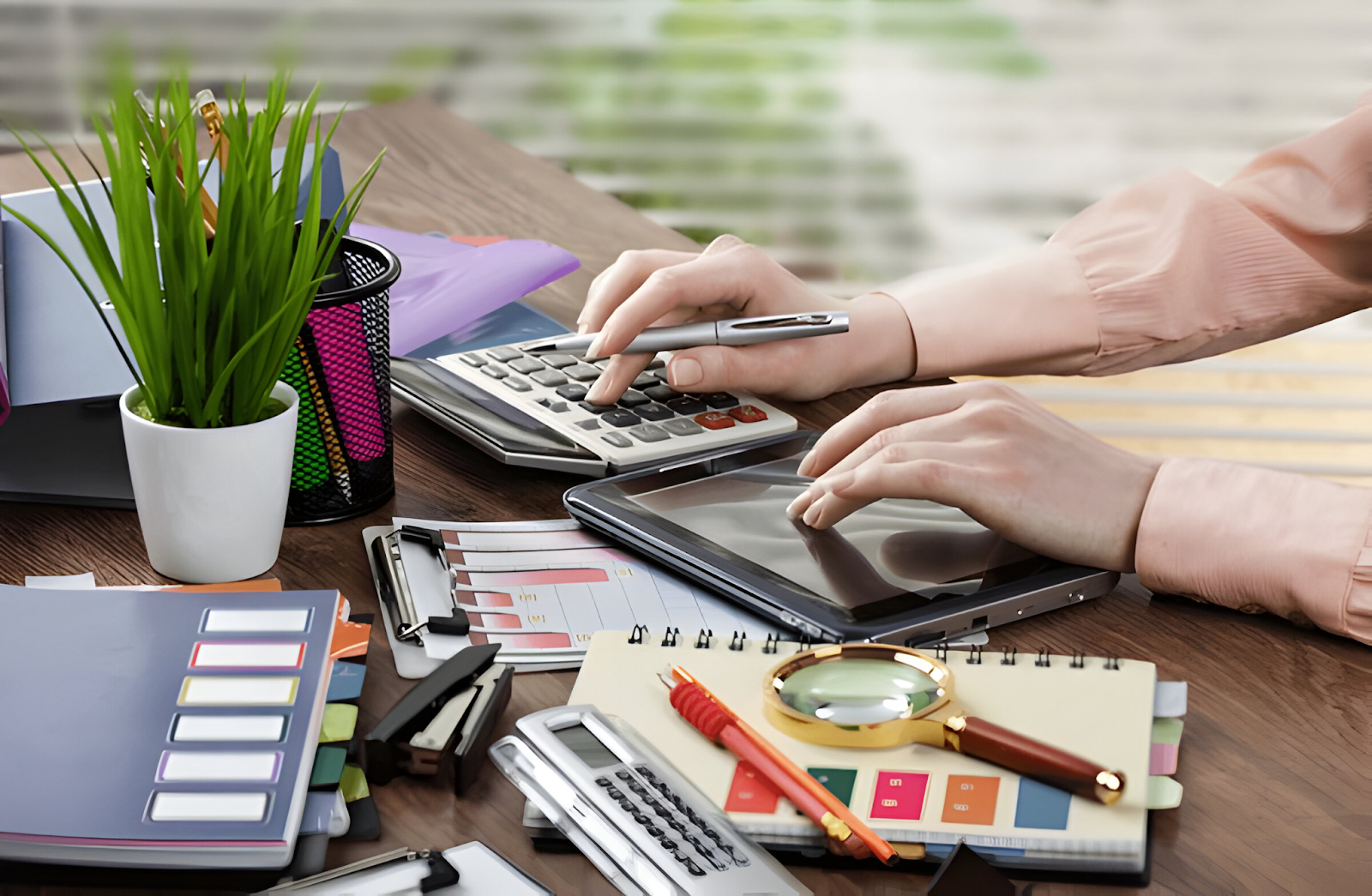 Accountant working with a calculator, tablet, and financial documents on a cluttered desk, symbolizing the challenges of managing complex financial tasks in accounting.