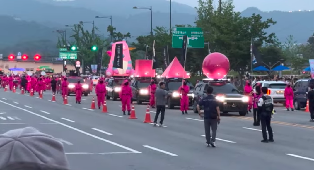 This contains an image of Squid Game Seoul parade
