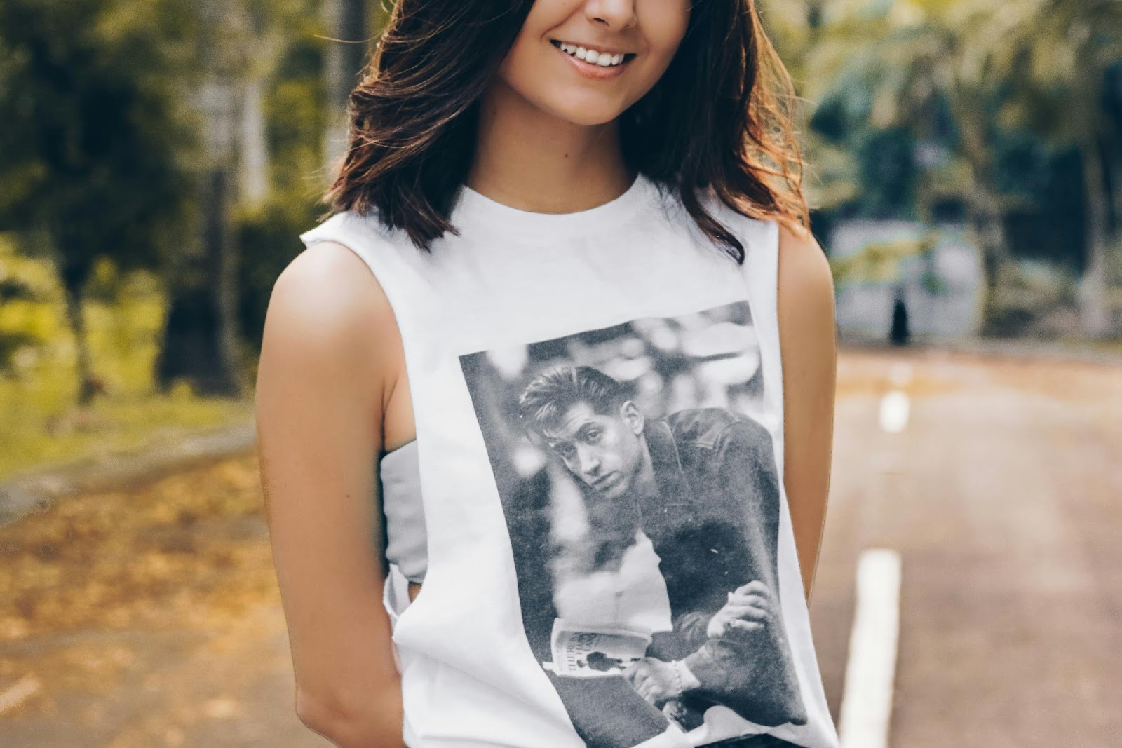 a woman smiling with a drawing on her shirt