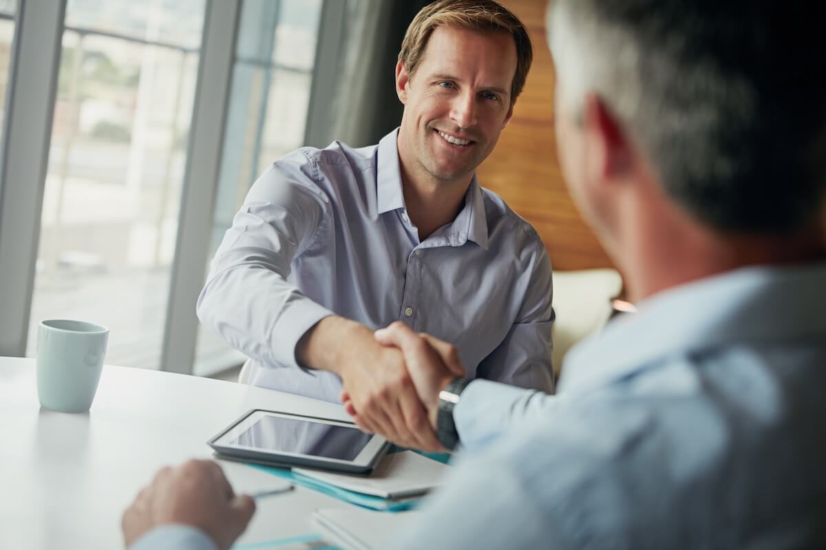 HR manager shaking hands with an employee