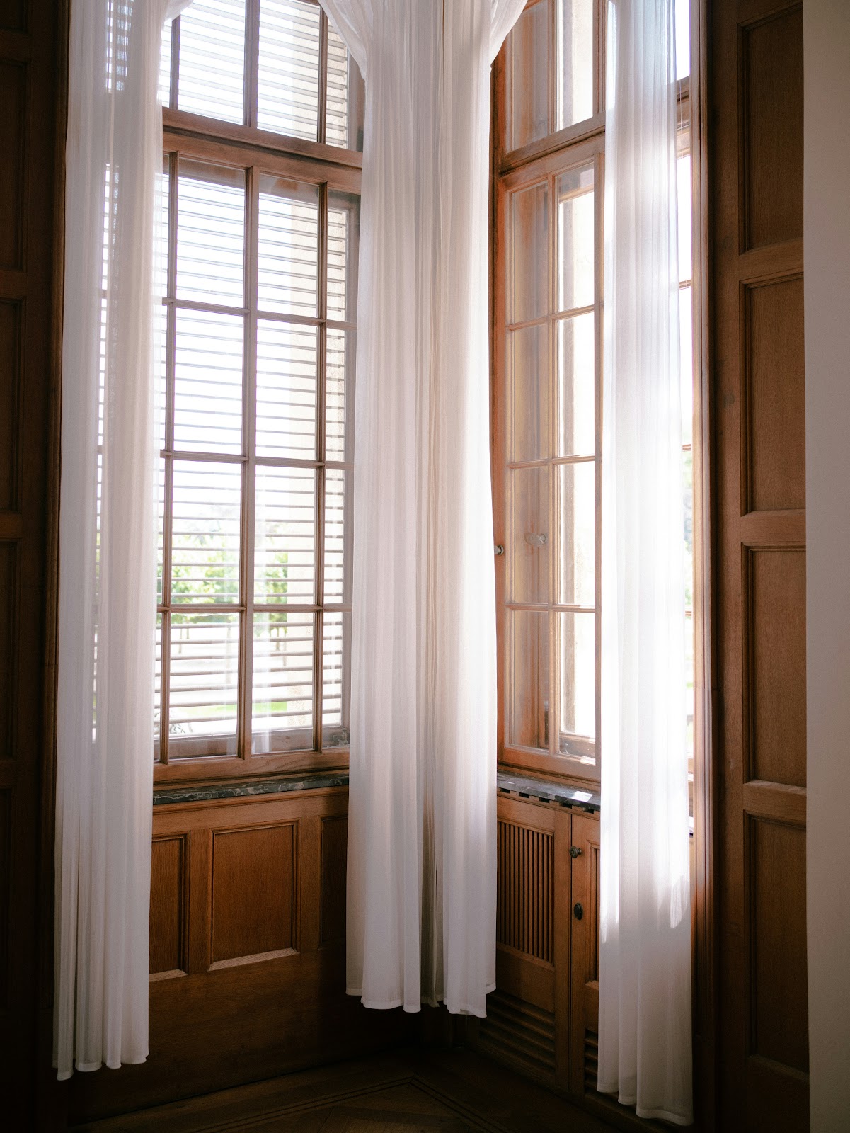 Bright room with sheer curtains and layered lighting for interior designing 