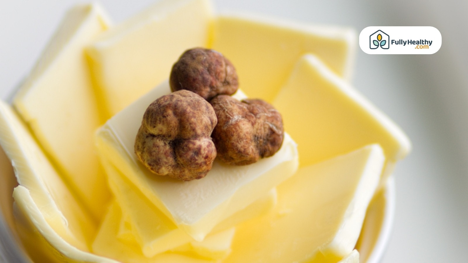 White truffle placed on top of stacked slices of butter