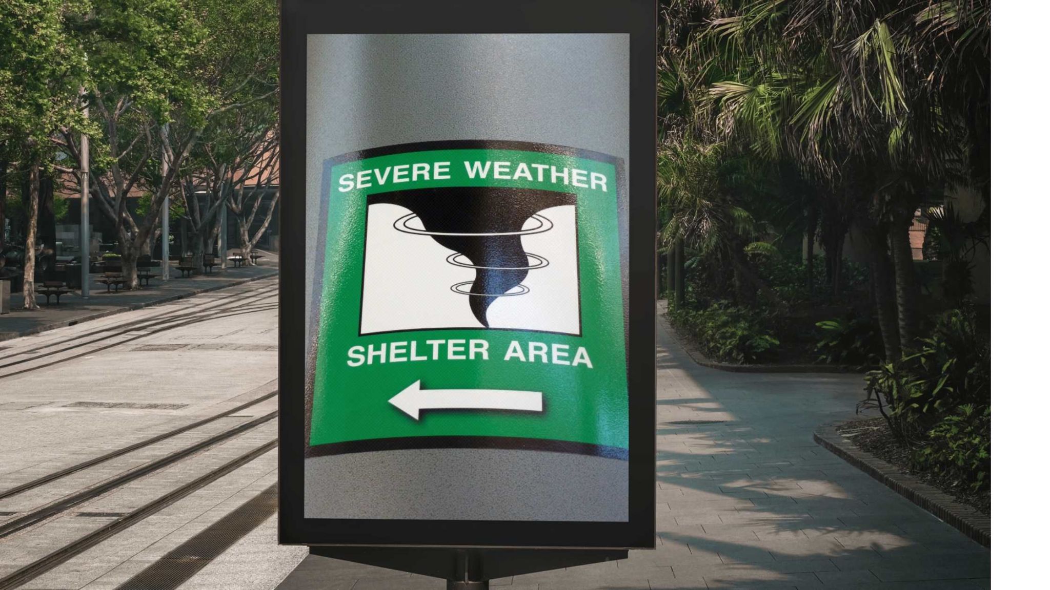 Outdoor Digital Display Qatar showing a public emergency sign for "Severe Weather Shelter Area" in a city environment with greenery and pedestrian walkways.