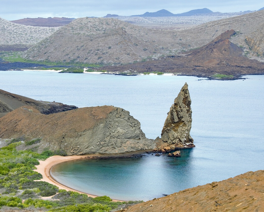 View of the Galápagos Island with rugged terrain and surrounding ocean.