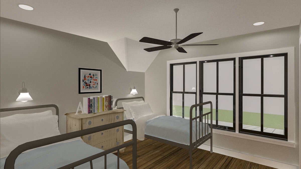 This bedroom offers two metal beds and a wooden dresser topped with books.