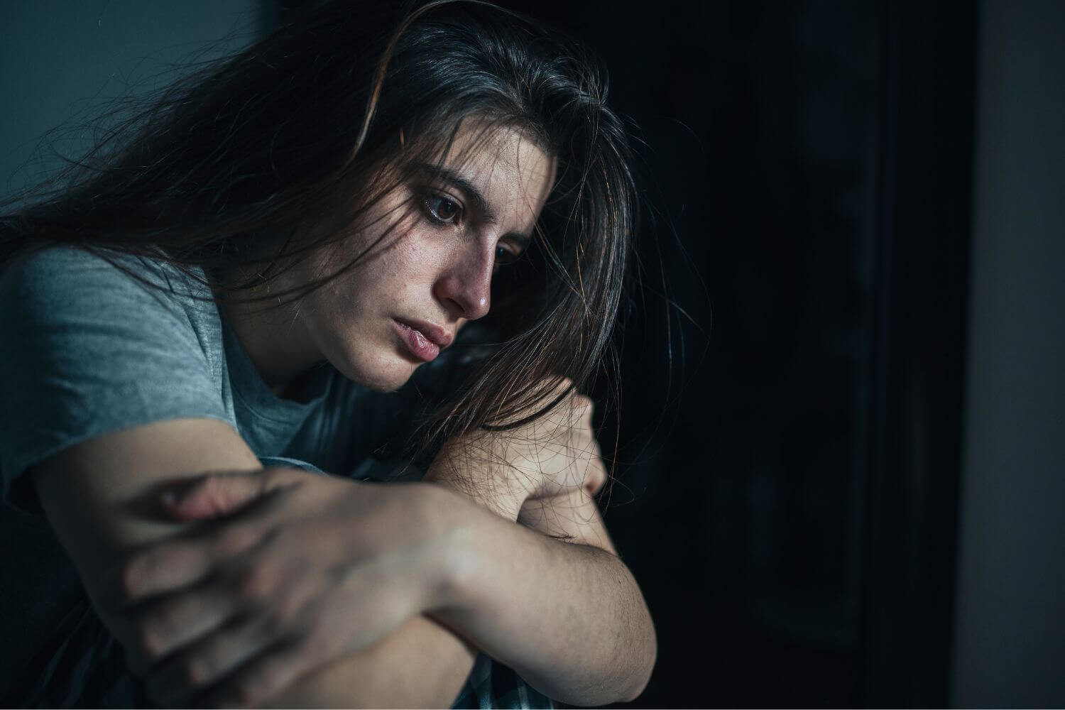 depressed woman looking off in a daze