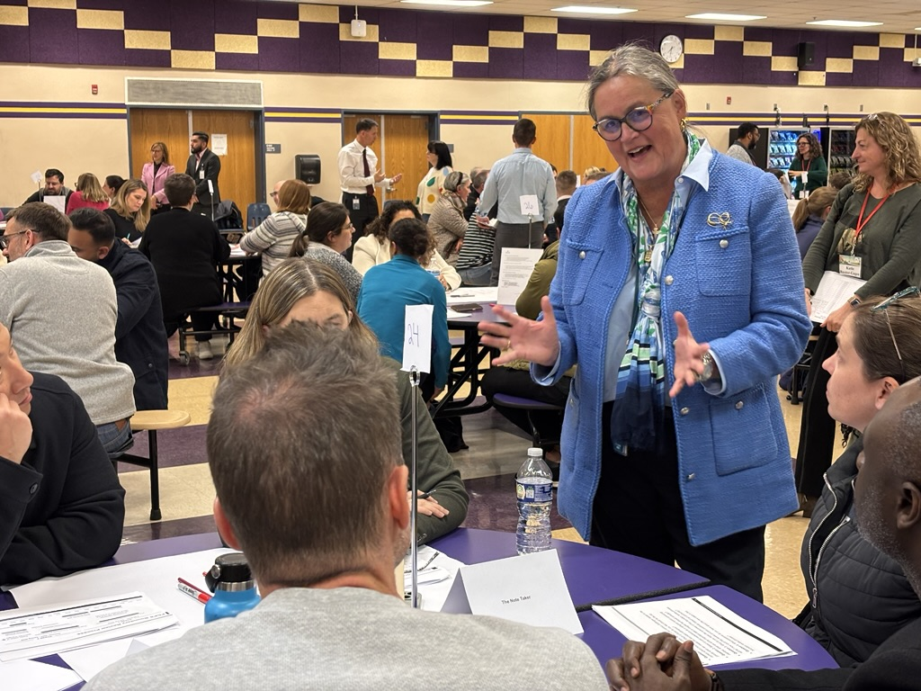 Dr. Reid speaking to a parent at a Boundary Review Community meeting at Westfield High School. 