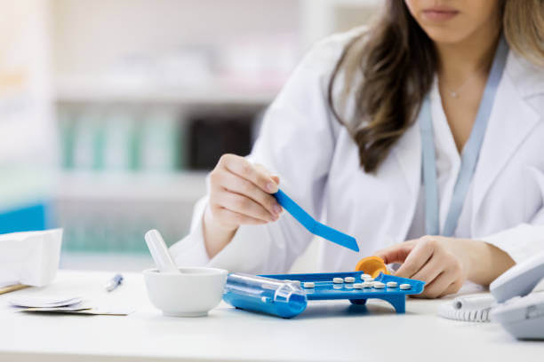 A skilled pharmacist carefully preparing a custom medication in a compounding lab, showcasing precision and personalized healthcare solutions.