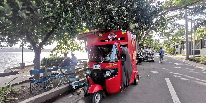 A red truck parked on the side of a road

Description automatically generated