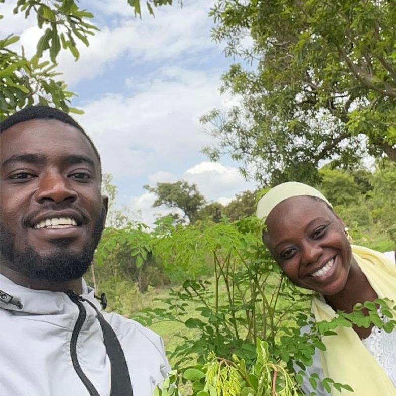 A person and person posing for a picture

AI-generated content may be incorrect.