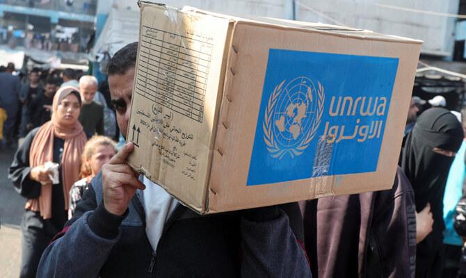 A Palestinian man carries an aid box distributed by the United Nations Relief and Works Agency (UNRWA), amid the Israel-Hamas conflict, in Deir Al-Balah, central Gaza Strip, November 4, 2024. (Reuters)