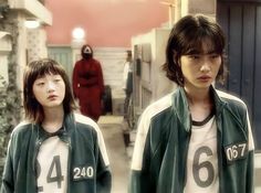 This  contain an image of  Jo Yuri. standing next to each other in front of a red door with numbers on them