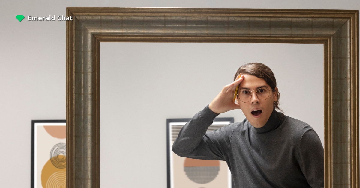 A man looking himself in the mirror