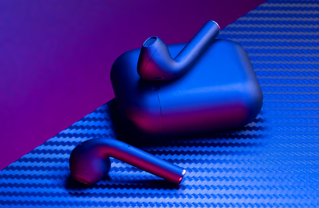 Close-up of modern noise-canceling earbuds resting on a sleek surface.