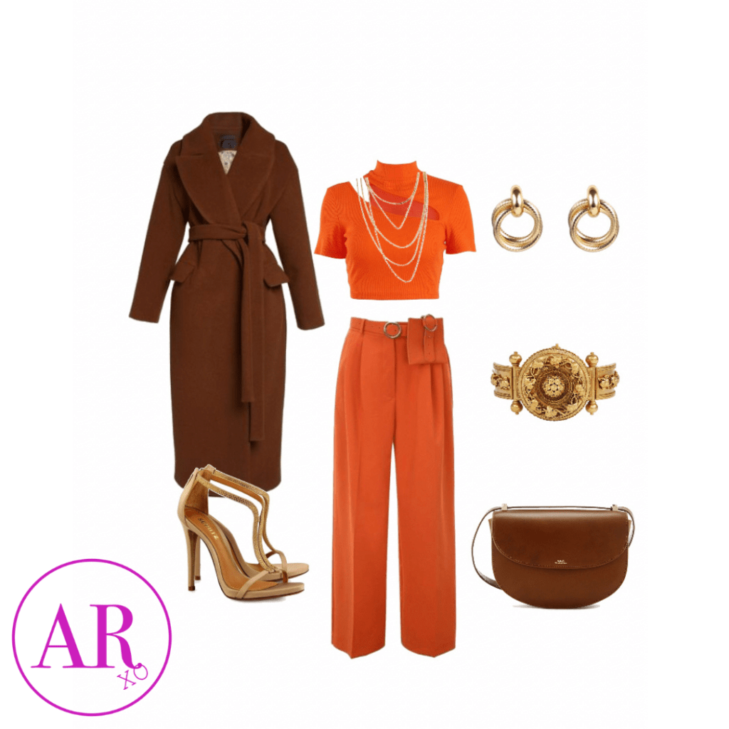 brown trench coat, bright orange crop top with open shoulder and chest, orange wide leg dress pants, gold high heels, gold watch-like face bracelet, small gold hoop earrings, and a brown clutch purse. 