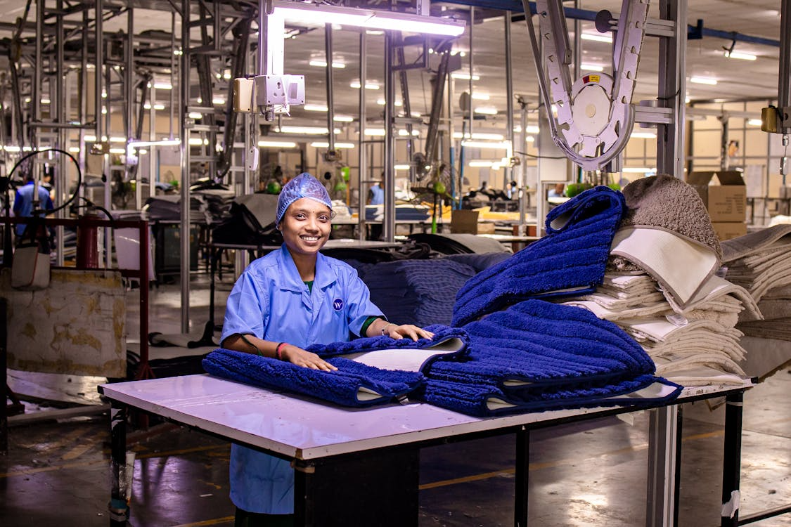 Worker in modern manufacturing plant, highlighting the scope of incident management and its role in workplace safety.