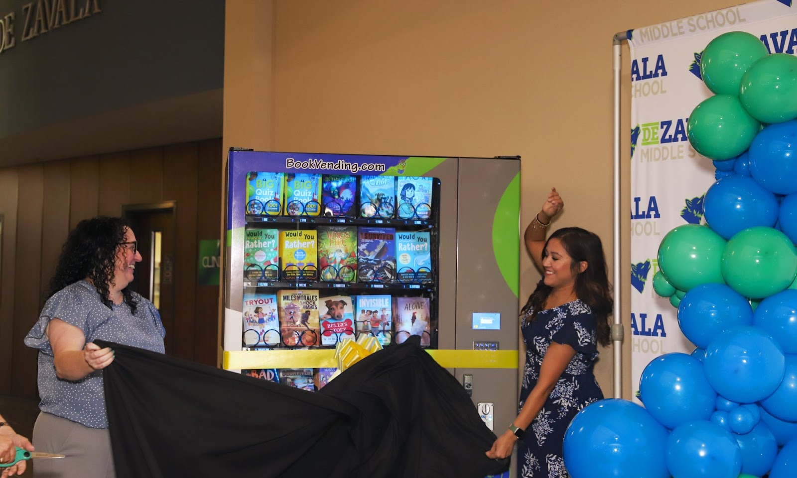 teachers reveal new book vending machine