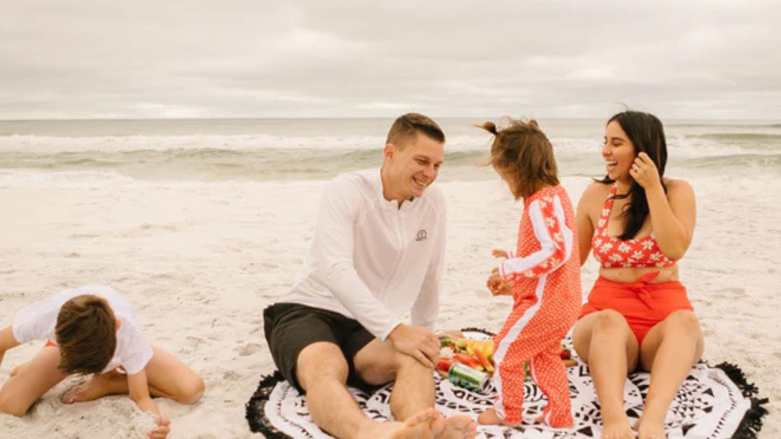 Family at the SwimZip's beach towel enjoy time in Swimzip swimwear—How to choose a fabric for swimwear (a complete guide)