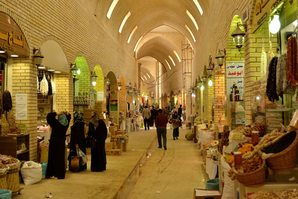Interior view of the Qaysari Bazaar in Erbil, Iraq, showcasing traditional shops and vendors selling spices, dried fruits, and other local goods.