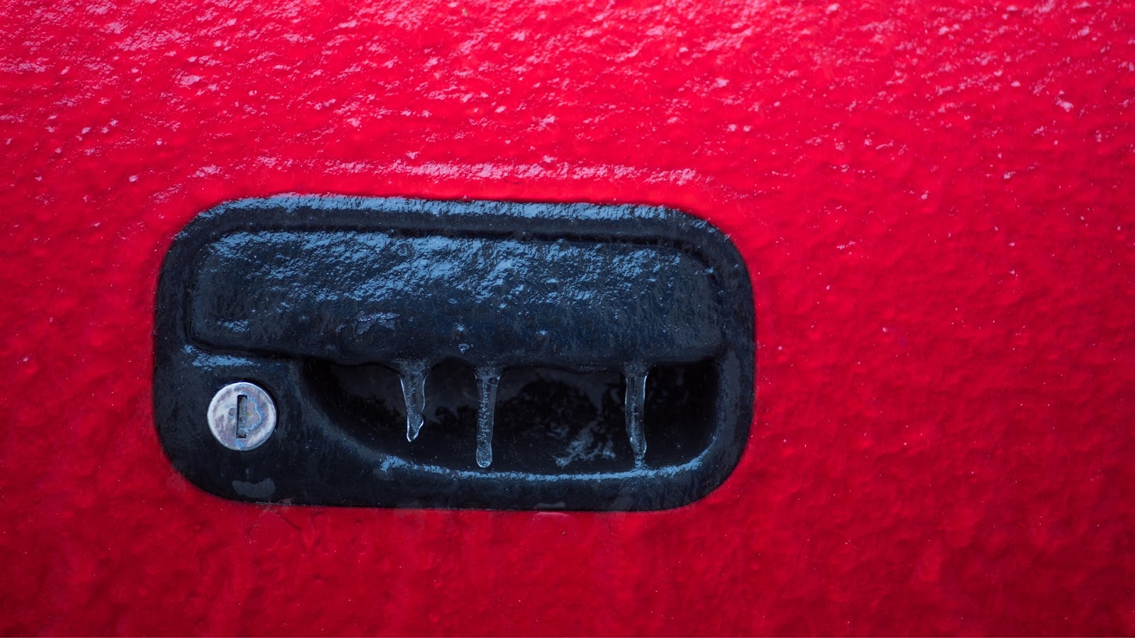 A car lock covered with frost needing repair