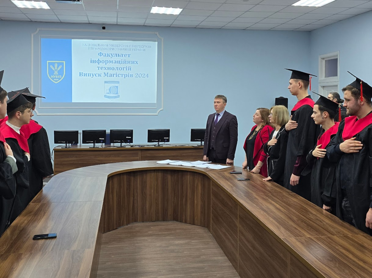 A person standing in front of a podium with a person in a graduation gown

Description automatically generated