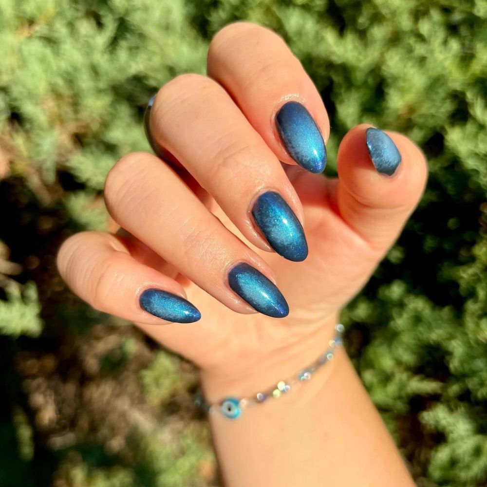 Close up of hands with blue winter nails having Silver and blue Winter Nail art