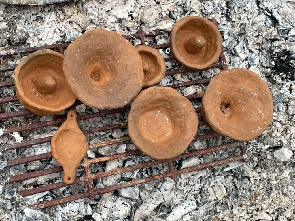 Clay pots on a metal grate

AI-generated content may be incorrect.