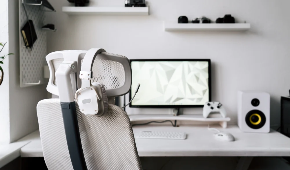 Image of a gaming PC setup including a chair, monitor, speaker and peripherals