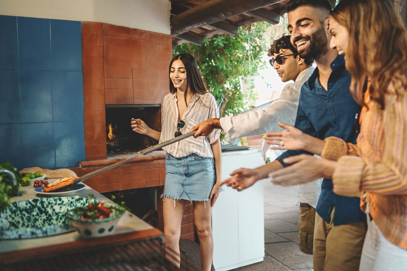 People making food at an outdoor gathering