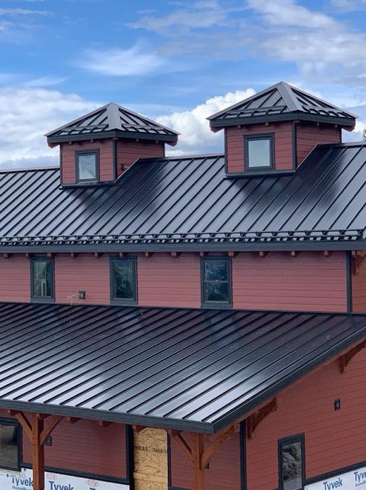 Barn with a metal roof and snow guards