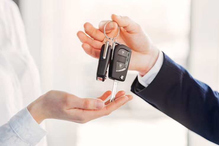 A person handing over a car keysAI-generated content may be incorrect.