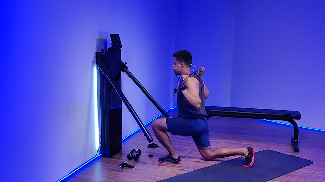 A man using dumbbells on an all-in-one workout machine, showcasing its versatility for strength training and full-body exercises.